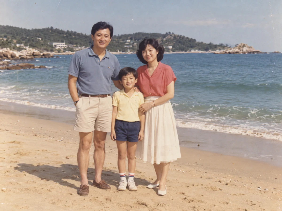Faded vintage color photograph of a family at the seaside